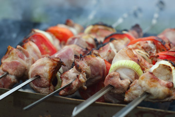Grilling shashlik on barbecue grill