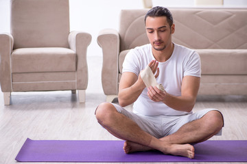 Fototapeta premium Hand injured man doing exercises at home