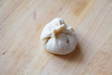 preparation of a dough for baking on a chopping board - preparing Slovakian steamed buns