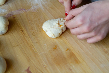 preparation of a dough for baking on a chopping board - preparing Slovakian steamed buns