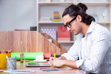Young male designer working in the office
