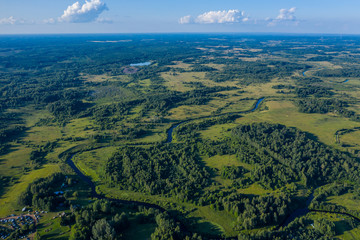 Aerial view of a winding river in a green country