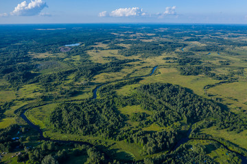 Aerial view of a winding river in a green country