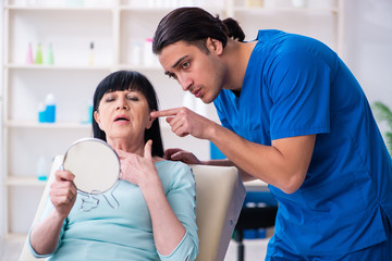 Fototapeta premium Old woman visiting male doctor for plastic surgery