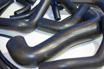 Spare parts for cars. nozzles for engine machines. On the table are rubber tubes of various...