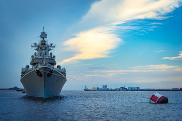 Missile cruiser. Military ship against the backdrop of a beautiful sky. Naval forces. Protection of maritime borders. The destroyer guards the strait at sea. © Grispb