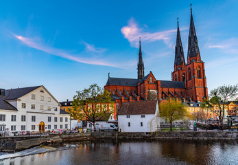 Sunset view of white building of Uppland museum and cathedral in Uppsala, Sweden