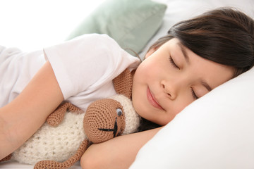 Little girl sleeping in bed at home