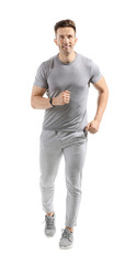 Fototapeta premium Running young man on white background
