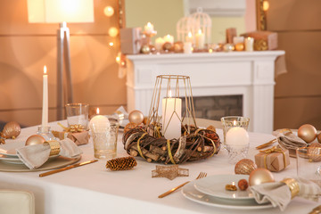 Beautiful table setting with Christmas decorations in living room
