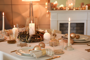 Beautiful table setting with Christmas decorations in living room