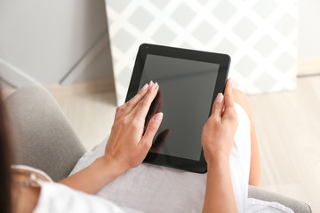 Young woman with tablet computer at home