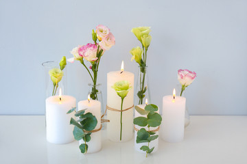 Composition with beautiful burning candles and flowers on table