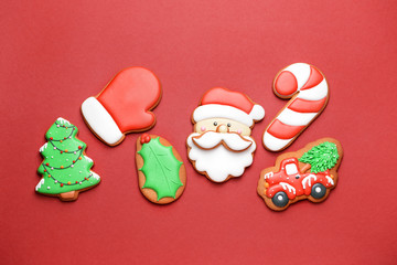 Tasty Christmas cookies on color background