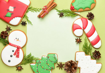 Composition with tasty Christmas cookies and paper on color background