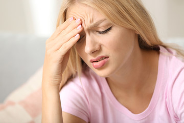 Stressed young woman at home