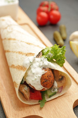 Board with tasty falafel pita on table, closeup