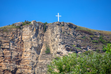Fototapeta na wymiar white orthodox cross on the mountain peak