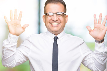 Middle age bussines arab man wearing glasses over isolated background showing and pointing up with fingers number ten while smiling confident and happy.