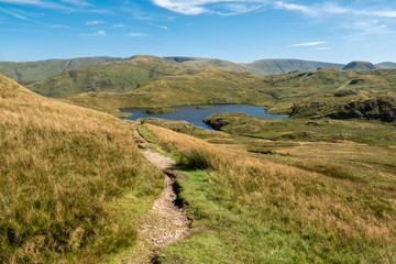 Hikking between Brotherswater and Angle Tarn near Patterdale in the English Lake Districr surrounded by many Wainwrights