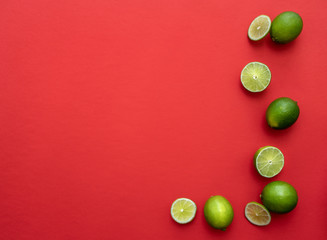 colorful slices of limes isolated on red background