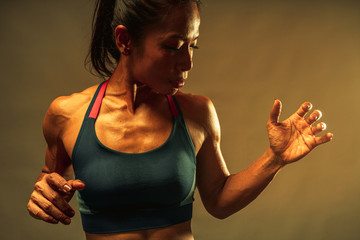 close up of the top part of muscle lean healthy body of 40 year old asian woman in fitness training...