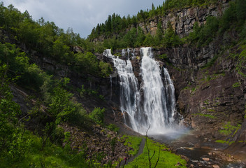 Fototapeta na wymiar Frontal view of the Skjervsfossen in summer, seen from the base. Norway. July 2019