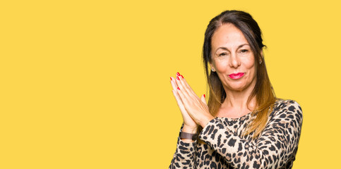 Beautiful middle age woman wearing leopard animal print dress Clapping and applauding happy and joyful, smiling proud hands together © Krakenimages.com