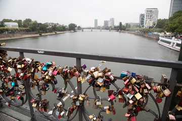 Locks on a bridge with city scape in background