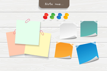 Set of different note papers on wooden background.