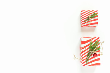 Obraz premium New Year Christmas holiday celebration gift box with decor on white background. Flat lay, top view, copy space. Minimal style