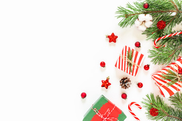 Christmas and New Year holydays composition. Fir tree branches, gifts and decor on white background. Flat lay, top view. Copy space