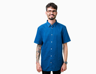 Fototapeta premium Young handsome man wearing glasses over isolated background with a happy and cool smile on face. Lucky person.