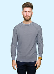Fototapeta premium Young handsome man wearing stripes sweater skeptic and nervous, frowning upset because of problem. Negative person.
