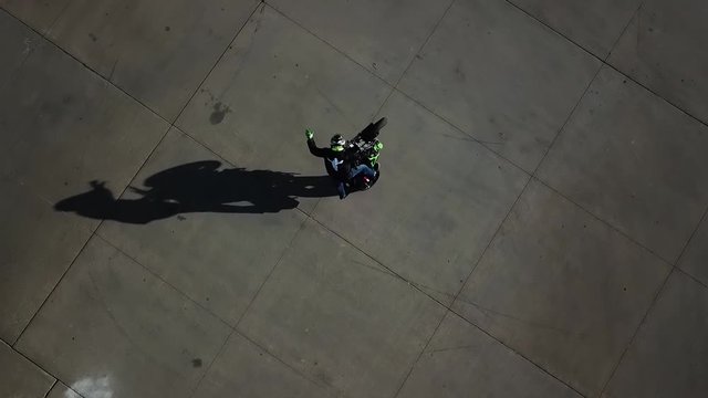 Aerial Drone Shot of a motorcycle doing circular wheelies. Shot in Wichita Kansas.