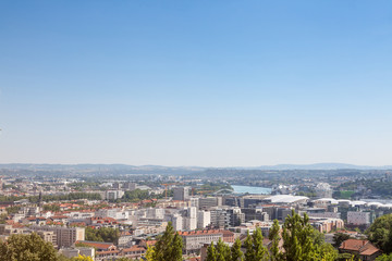 Fototapeta na wymiar Aerial panoramic view of Lyon with the outskirts and suburbs of Lyon visible in background and Rhone river in the foregroud. Lyon is the second biggest city of France