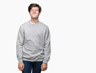 Young handsome sporty man wearing sweatshirt over isolated background puffing cheeks with funny face. Mouth inflated with air, crazy expression.