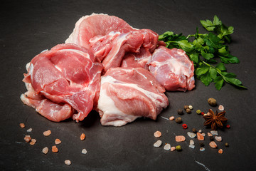 top view on small meat pieces with spices and parsley