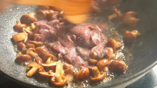 Frying shiitake mushroom with liver pork in pan, Chiangmai Thailand