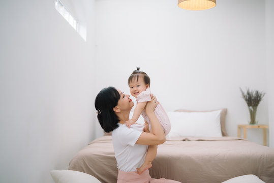 asian mother and child relaxing on the bed room