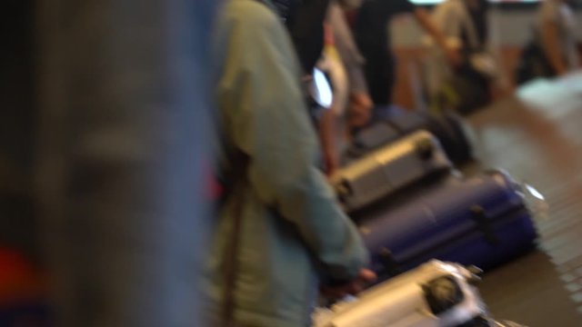People are claiming their baggages on conveyor belt