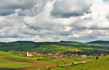 Obraz premium landscape with a village between hills in Romania