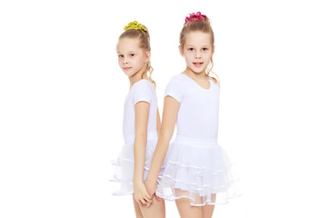 2 girls gymnast in white suits.