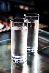 Cold fresh drinking water in glass on table