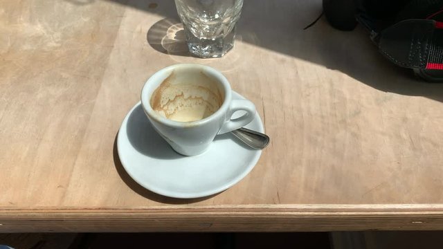an empty espresso cup on a table top
