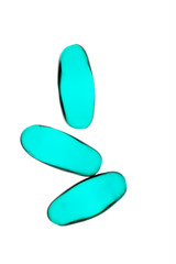 Bad shape expired blue pills on background