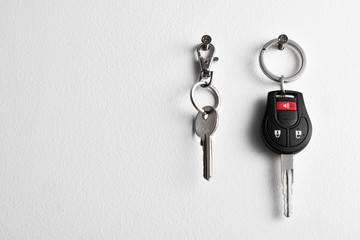 Car and house keys hanging on wall - Powered by Adobe
