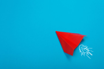 Red paper rockets or paper planes on a beautiful light blue background.