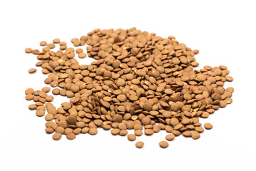 Isolated stack of uncooked lentils on white background from above.