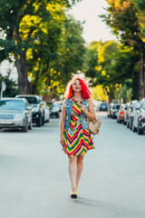 Fototapeta premium woman in dress walking on street